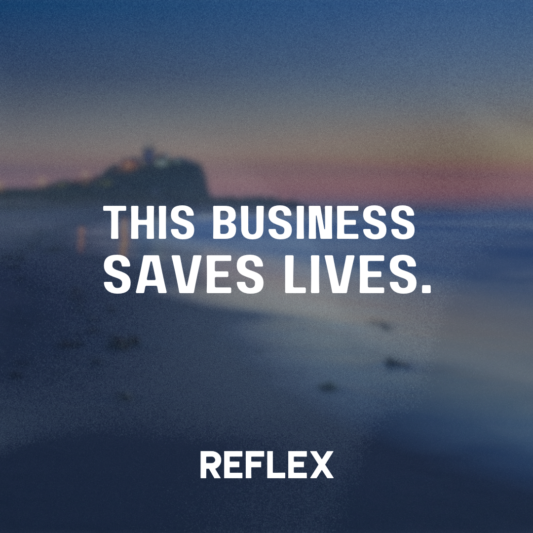 White text on a dark background. The text says "This business saves lives", while Nobby's beach is in the background.
